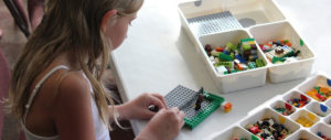 A little girl working with Legos